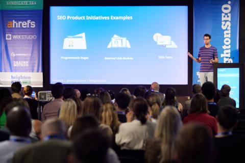 Gus Pelogia on stage at a conference